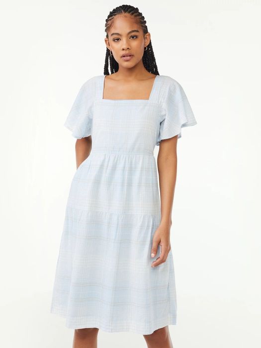 The model is wearing the light blue plaid dress.