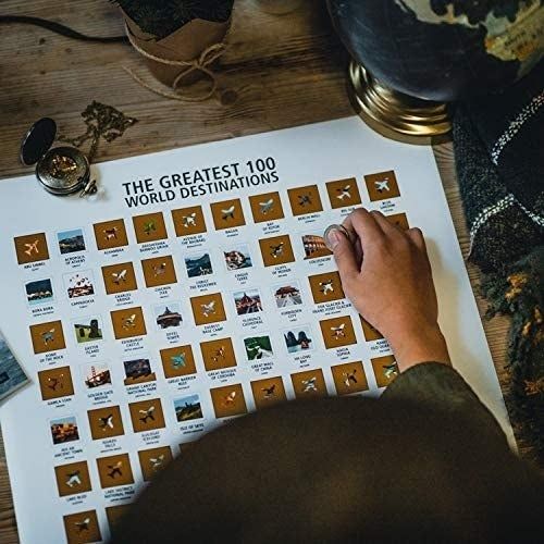 A poster titled 'The Greatest 100 World Destinations' featuring gold scratch-off squares that reveal stunning photos underneath