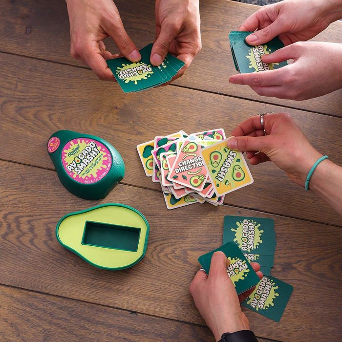 the card game packaged in a box shaped like an avocado