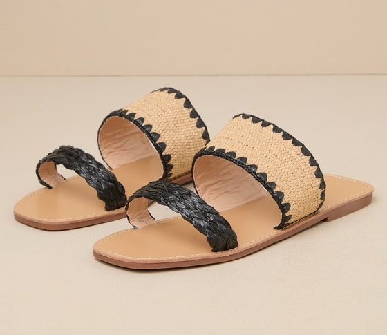Close-up of a pair of chic woven sandals featuring black braided straps and a wide natural-colored band with black scalloped edges across the top