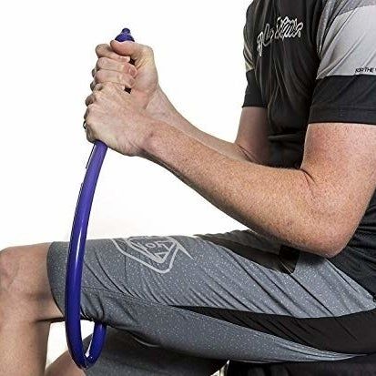 A person using the massager to relieve tension in the area around his knee