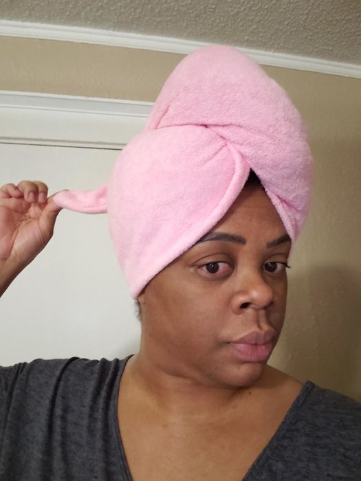 A reviewer wearing a pink Turbie Twist towel