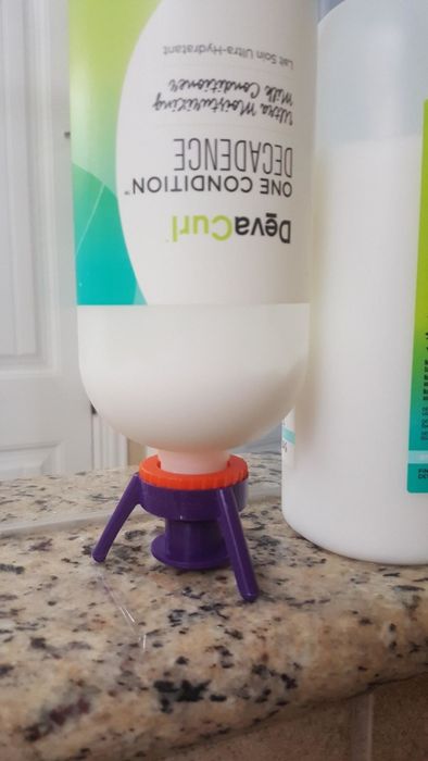 a bottle securely placed upside down on the three-pronged stand