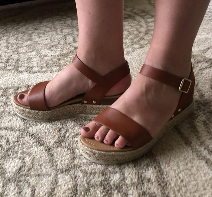 A reviewer wearing brown sandals