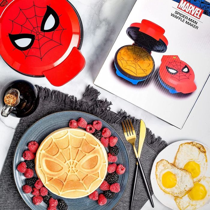 a Spider-Man-shaped waffle next to the matching waffle maker