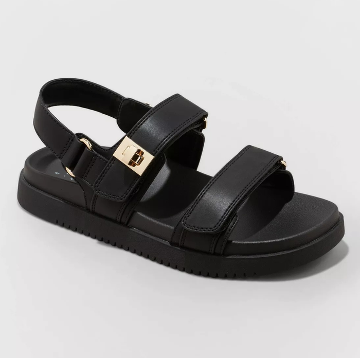 Black sandal with adjustable ankle and toe straps, gold buckle detail, and cushioned sole