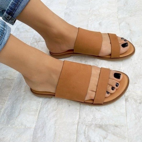 A model showcasing the brown sandals