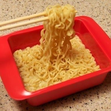 A batch of ramen, cooked in the square red cooker, ready to be devoured