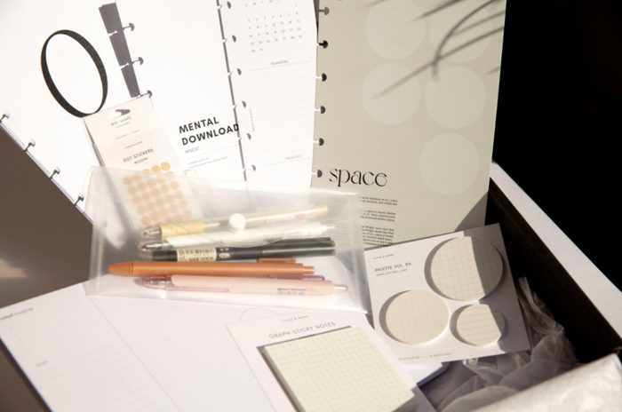 the interior of the box featuring white and tan planning supplies
