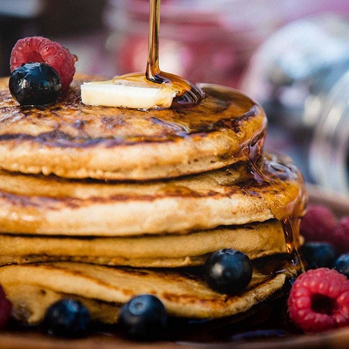 A plate of freshly made pancakes, steaming and golden-brown