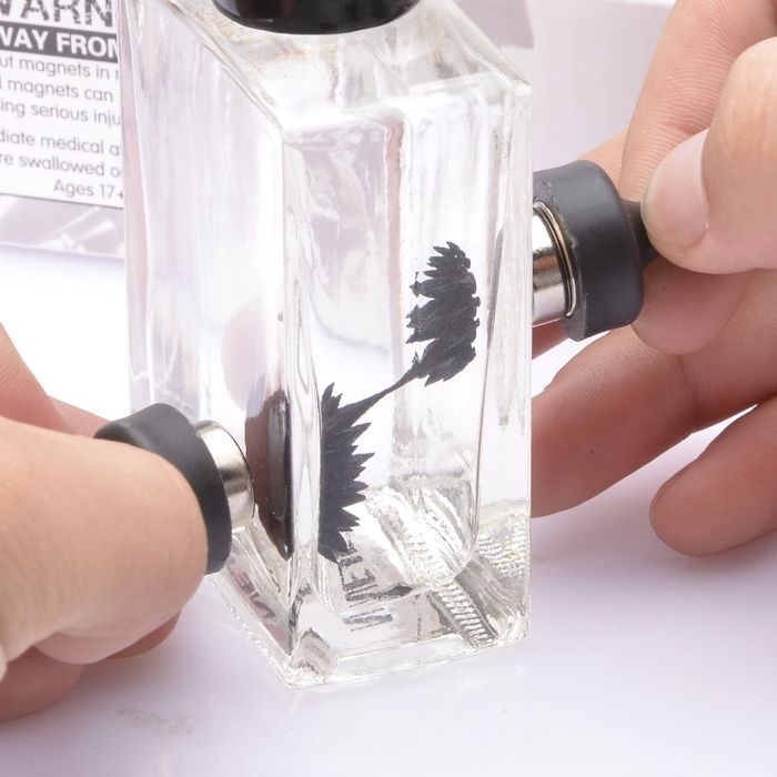 a model that utilizes magnets to create spiky formations with black liquid inside a glass bottle