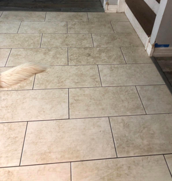 A reviewer's tile floor looking grimy and unclean
