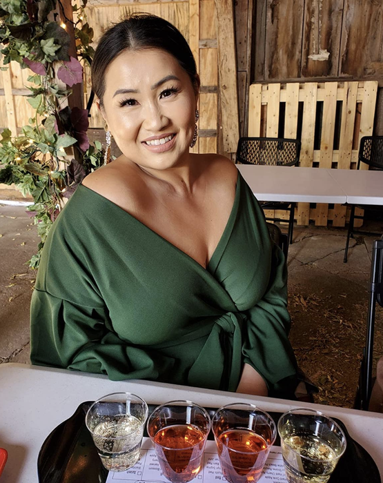Reviewer wearing the green off-shoulder top