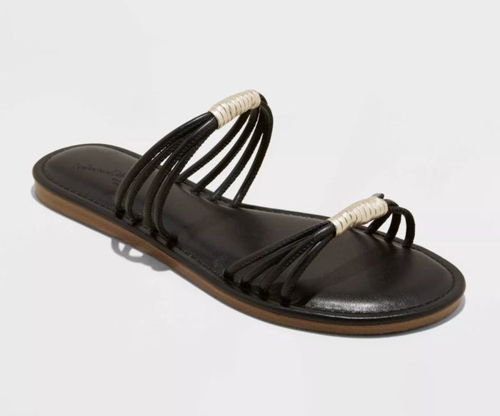 A single-strapped flat sandal with several delicate straps and subtle detailing across the top