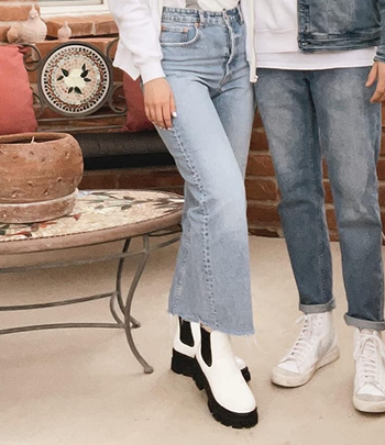 Reviewer wearing white and black boots