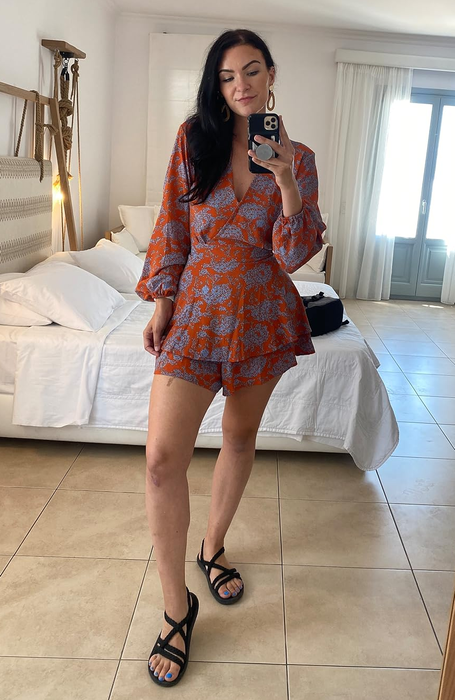 The reviewer is seen wearing the black sandals paired with a cute outfit.