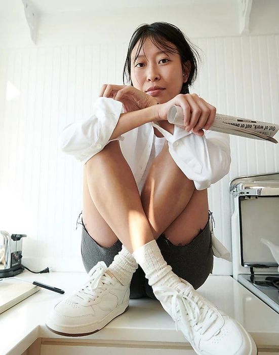 Model showing off the white sneakers