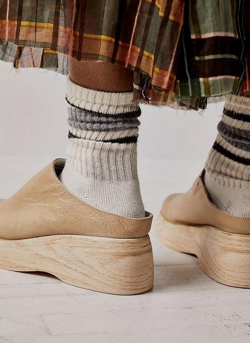 a person wearing the tan clog