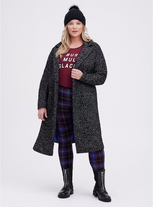 A model wearing the black and white speckled coat