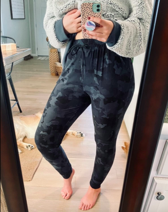 A reviewer showcasing the joggers in Gray Camouflage