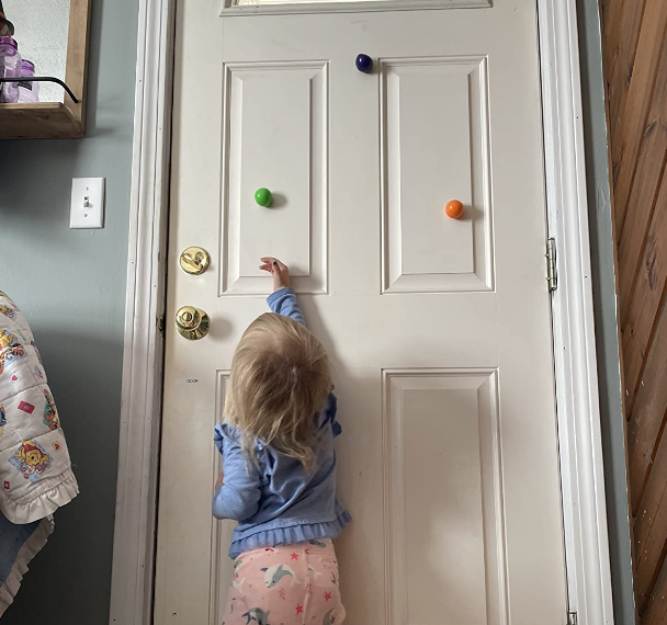 The reviewer's child has placed the Globbles on the front door, adding a fun twist to the home decor.