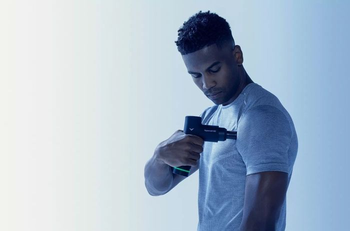 A model demonstrating the massage device as it soothes a tight shoulder muscle, providing relief with ease.