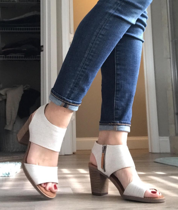Side view of reviewer wearing white sandals