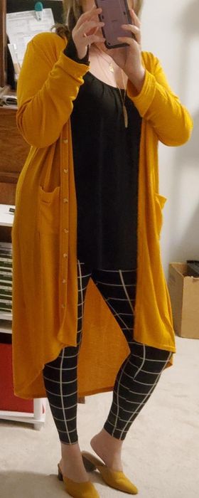 A reviewer styling the cardigan in bright yellow.