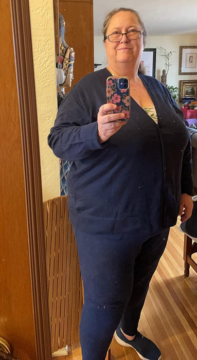 A reviewer showcasing the cardigan in navy blue