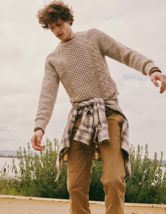 Model wearing a soft, heathered cream sweater