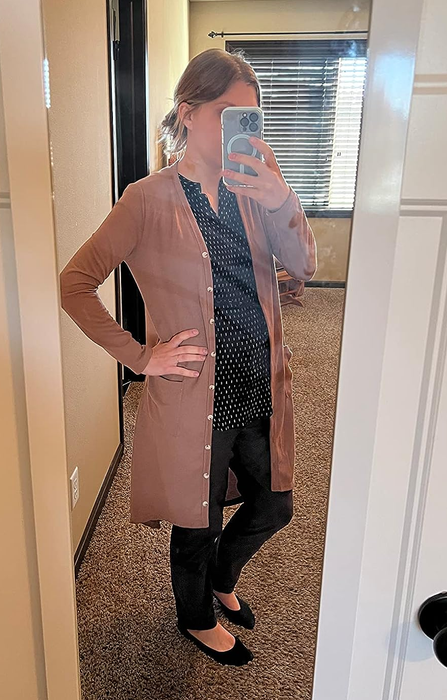 A reviewer wearing the cardigan in light brown.