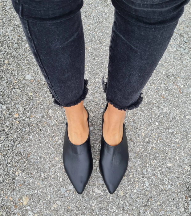 Model showcasing the black leather loafers