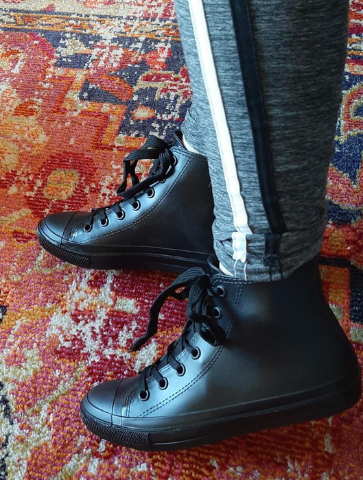 Reviewers sporting black Converse-style high-tops