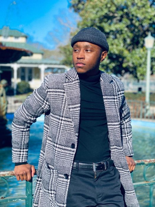 A reviewer rocking the white and black plaid coat