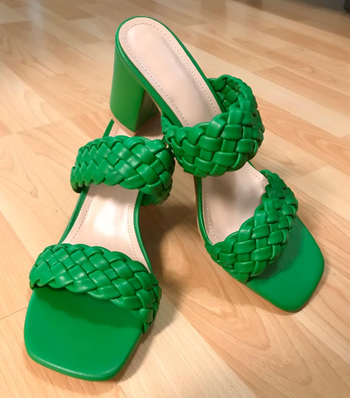 A pair of green braided high-heeled sandals