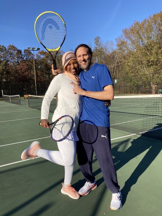 a reviewer sporting the shoes while playing tennis