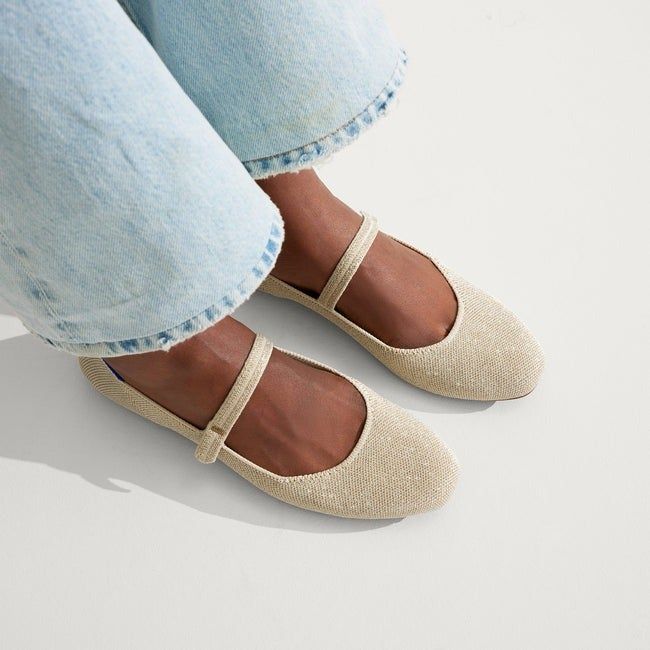 Close-up of a model’s feet in light gold metallic Mary Jane shoes, highlighting the chic finish.