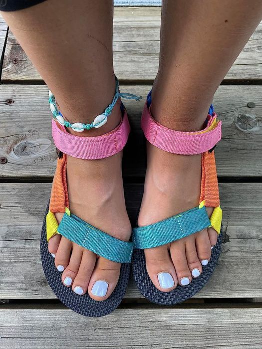 Reviewer's feet in vibrant Tevas sandals