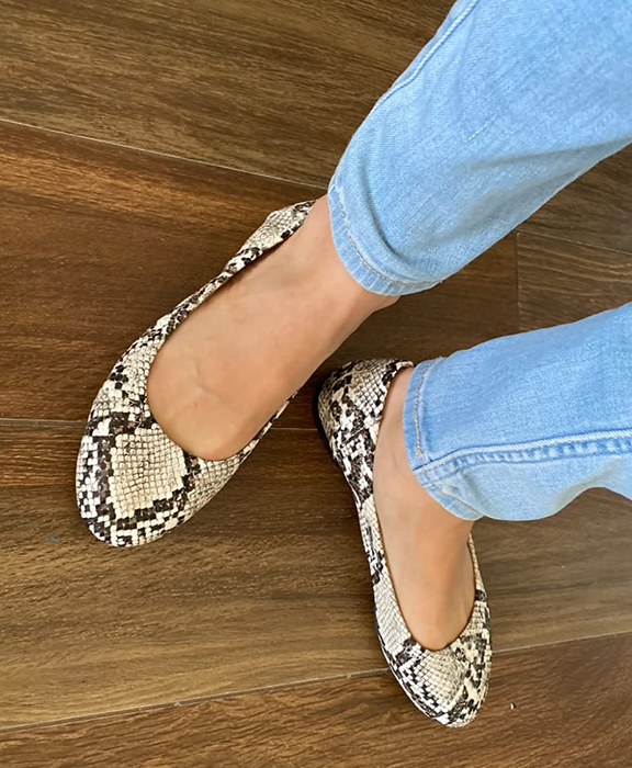 Reviewer wearing snakeskin flats paired with jeans