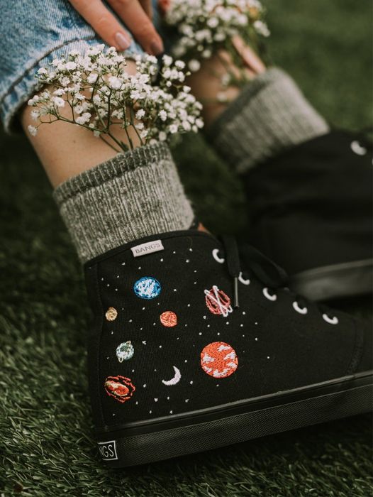 Black high-top sneakers with galaxy-themed designs