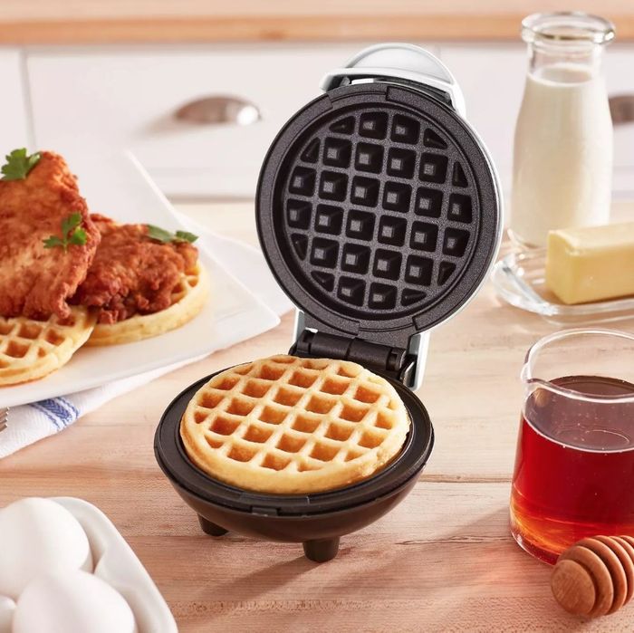 A compact waffle maker placed on a kitchen counter