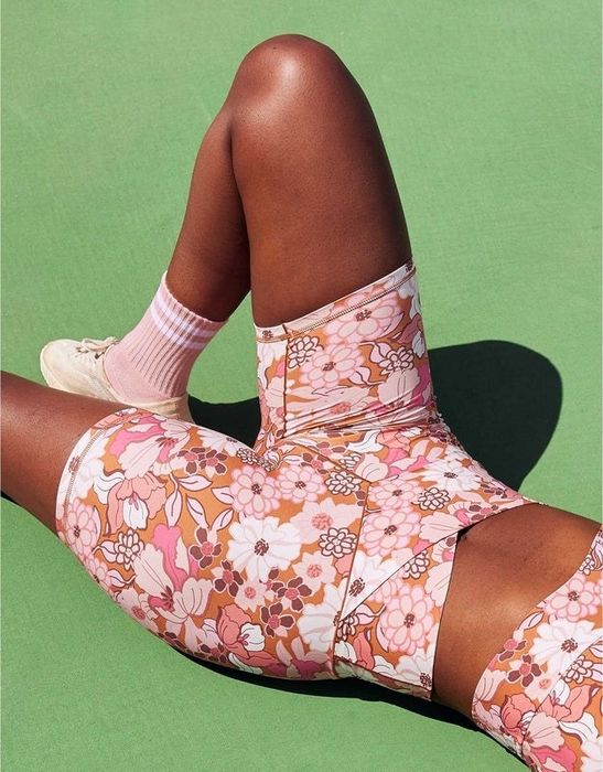 Model showing off the pink floral printed bike shorts, making a statement