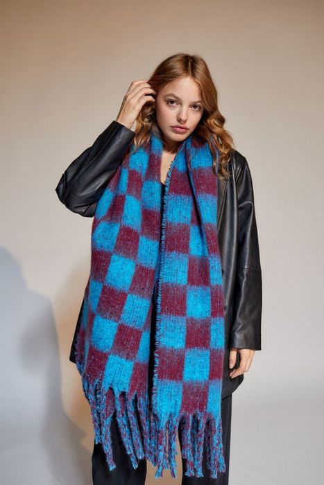 A model rocking a blue and maroon checkered scarf