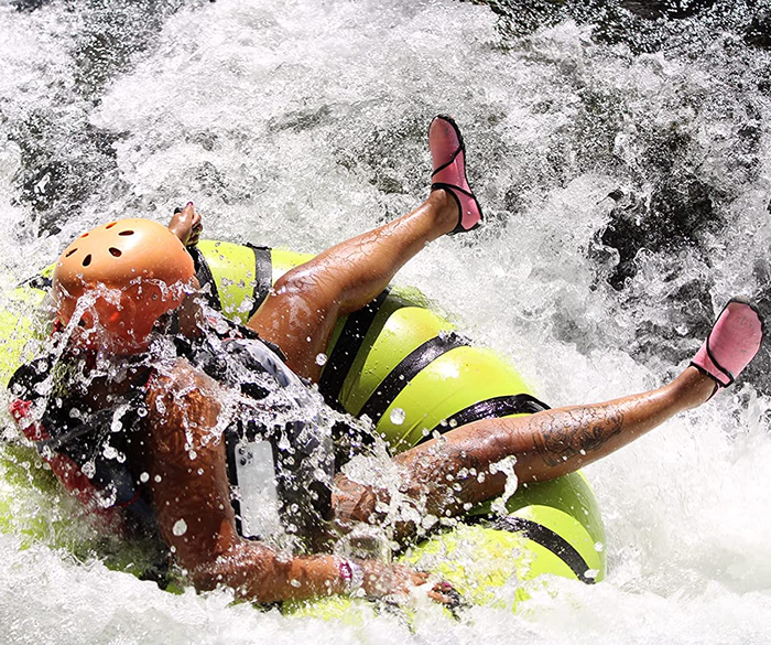 Reviewer rocking pink shoes while tubing on the water