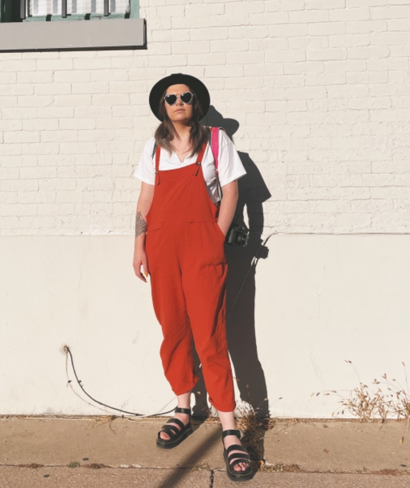 Reviewer wearing the overalls in a vibrant orange shade