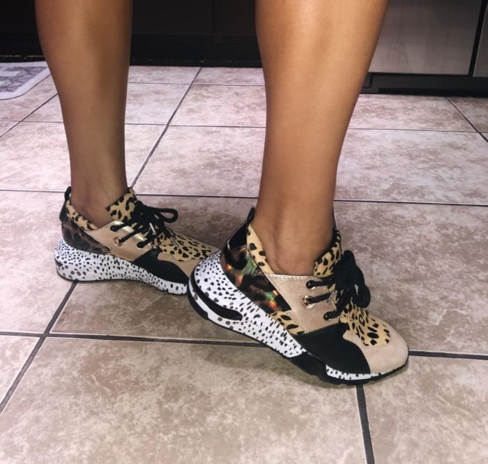 Reviewer showcasing the sneakers, highlighting the mix of colors and patterns