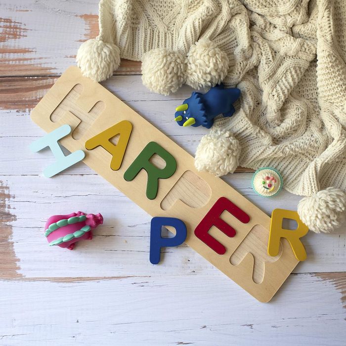 Personalized wooden name puzzle with mixed font letters for fun learning
