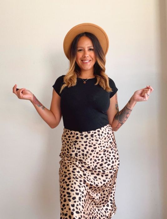 Reviewer styled in the same skirt, paired with a simple black tee