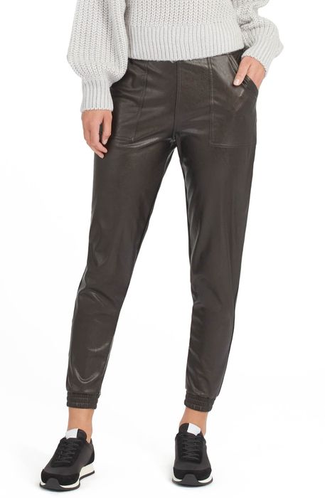 Model wearing the black faux leather joggers