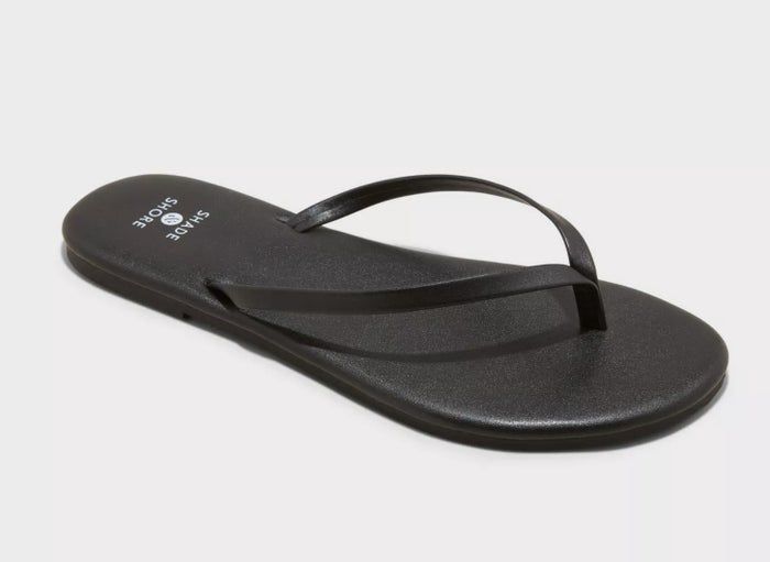 A single black flip-flop sandal with thin straps and a minimalist design